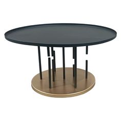 a round table with black top and gold base