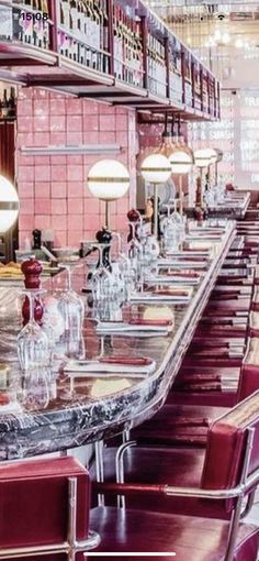 a long table with red chairs in a restaurant