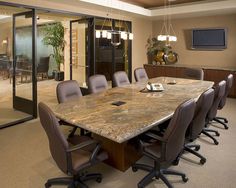 a conference room with marble top table and chairs