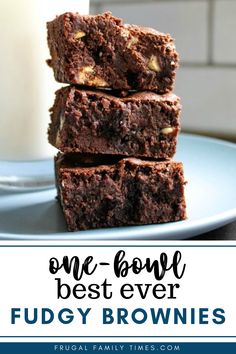 chocolate fudge brownies stacked on top of each other in front of a glass of milk