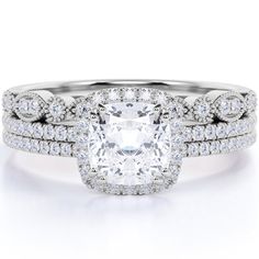 a cushion cut diamond surrounded by two rows of pave set diamonds on the band