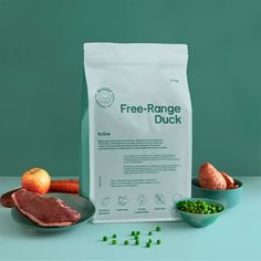 a bag of freeze - range duck next to some vegetables and meat on a plate