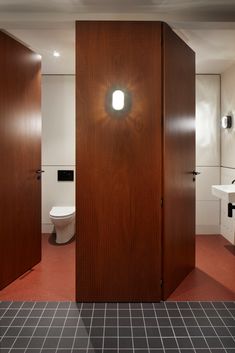 the bathroom has two stalls with lights on them