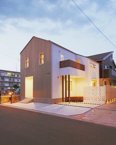 a modern house is lit up at night in the evening with no one around it