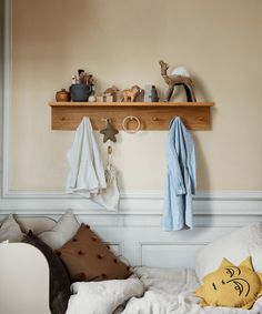 there is a shelf above the bed with toys on it