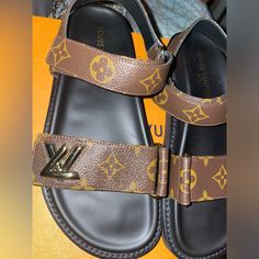 Louis Vuitton, Comfort Sandal, Lv Gold Accessory, Adjustable Velcro Straps, Comfort Trend, Never Worn Designer Brown Sandals For Vacation, Luxury Brown Sandals With Round Toe, Designer Brown Open Toe Sandals, Designer Open Toe Brown Sandals, Louis Vuitton Slides, Shoes Louis Vuitton, Rope Sandals, Louis Vuitton Red, Louis Vuitton Sandals