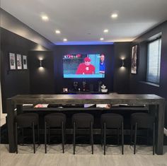 an entertainment room with chairs and a bar