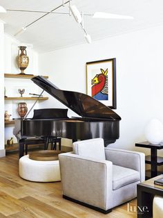 a living room filled with furniture and a grand piano