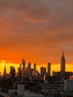 an airplane is flying over the city skyline at sunset or sunrise with orange and yellow colors