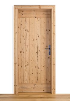 an open wooden door on a white wall