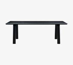 a black table sitting on top of a white wall