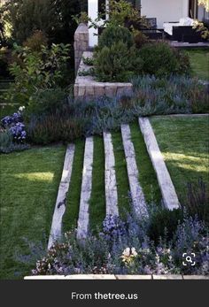 an outdoor garden with steps leading up to the house