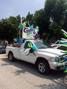 the truck is decorated with balloons and streamers in the shape of an antelope