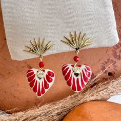 We combine art and elegance to create this beautiful piece. Our handmade earrings will be the perfect element to make your outfit standout. You could have the entire collection or gift them to someone special.  Material: Real Gold plate brass, Talavera gemstone  Dimensions: Drop Length 3cm, weight 2g Features : Lightweight, Unique and Simple design The Talavera of Puebla is part of the intangible heritage of humanity, declared by UNESCO. It is a type of majolica ceramic with a mixture of Chinese, Italian, Spanish, and indigenous techniques, and its colors are obtained from natural pigments. Its main characteristics are its vitreous finish and the use of bulky cobalt blue, this made it even more exclusive and ostentatious than Spanish craftsmanship. Its production requires at least 120 hour Handmade Festive Jewelry For Valentine's Day, Artisan Drop Earrings With Artistic Design, Artistic Heart Earrings As Gift, Elegant Handmade Earrings For Valentine's Day, Metal Earrings With Artistic Design For Gifts, Artistic Dangle Jewelry As Gift, Artistic Dangle Jewelry For Gifts, Artistic Design Dangle Jewelry Gift, Unique Festive Jewelry With Ear Wire