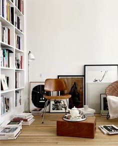 a living room filled with lots of books and furniture