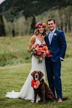 a bride and groom pose with their dog