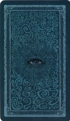 an eye is shown in the middle of a blue book with swirls on it