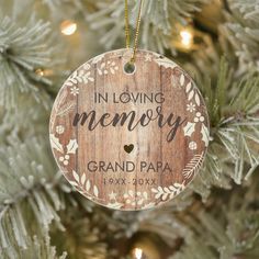 a wooden ornament hanging on a christmas tree that says in loving memory grand papa