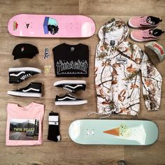 a skateboarder's gear laid out on a wooden floor