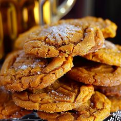 a pile of cookies sitting on top of a metal pan covered in powdered sugar