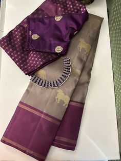 Pure kanchipuram silk saree woven in the korvai style , this saree is a signature Aavaranaa creation. The body has the kamadhenu motifs woven in pure zari, the border is kept simple but the pallu is richly woven in a traditional pattern with mythological figures and other smaller patterns like rudrakshams. This is an iced mocha with mauve border. The blouse piece is plain border colour Saree Colors, Draping Styles, Saree Draping Styles, Aari Blouse, Iced Mocha