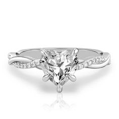 a white gold engagement ring with a heart shaped diamond in the center and side stones