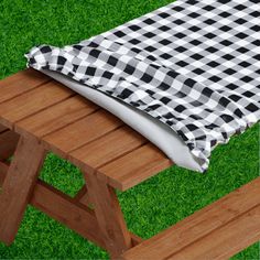 a black and white checkered tablecloth on a picnic bench