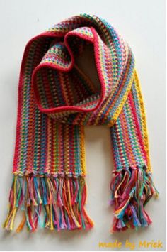 a multicolored knitted scarf with fringes