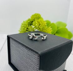 two silver rings sitting on top of a black box