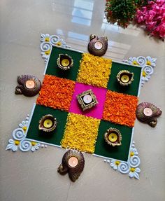 a decorated floor with flowers and candles on it for diwaling or decorating