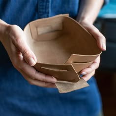 a person holding a brown paper bag in their hands