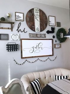 a living room filled with furniture and lots of clocks on the wall above it's coffee table