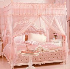 a bedroom with pink bedding and white furniture