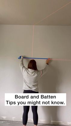 a woman standing in front of a white wall holding a board and baten tips you might not know