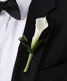 a boutonniere with a white flower attached to it's lapel