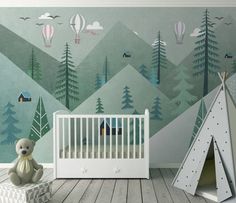 a baby's room with a crib and wallpaper that has hot air balloons in the sky