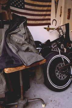 a motorcycle parked in a garage next to an american flag