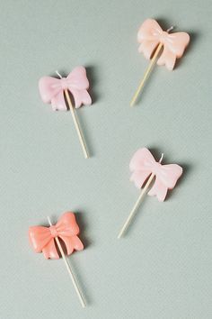 four pink bows on top of each other with toothpicks in the shape of bow