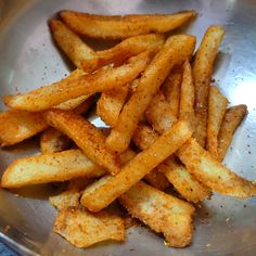 french fries in a bowl with seasoning on top