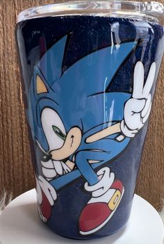 a blue cup with an image of sonic the hedgehog on it's side