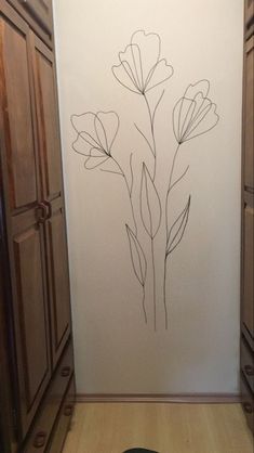 a drawing of some flowers on a wall