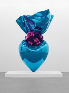 a blue vase that has been wrapped in foil