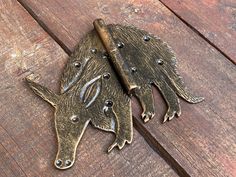 two metal animals are sitting on a wooden surface