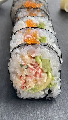 several sushi rolls are lined up on the table