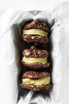 three chocolate cookies with avocado on top