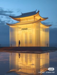 a person standing in front of a tall building with the word fendi on it