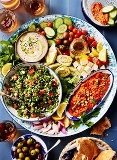 a platter filled with different types of food on top of a blue tiled table