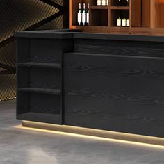 an empty bar with wine bottles on the shelves and behind it is a lighted shelf