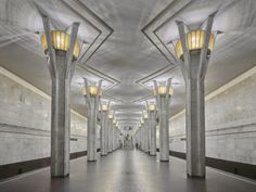 an empty hallway with lights and columns