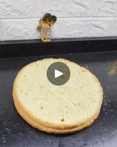 an uncooked pizza sitting on top of a black counter next to a door